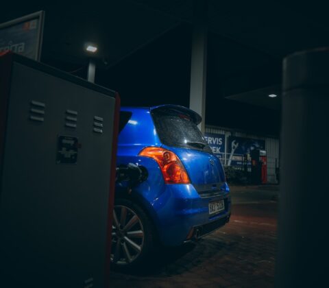blue car parked near white building